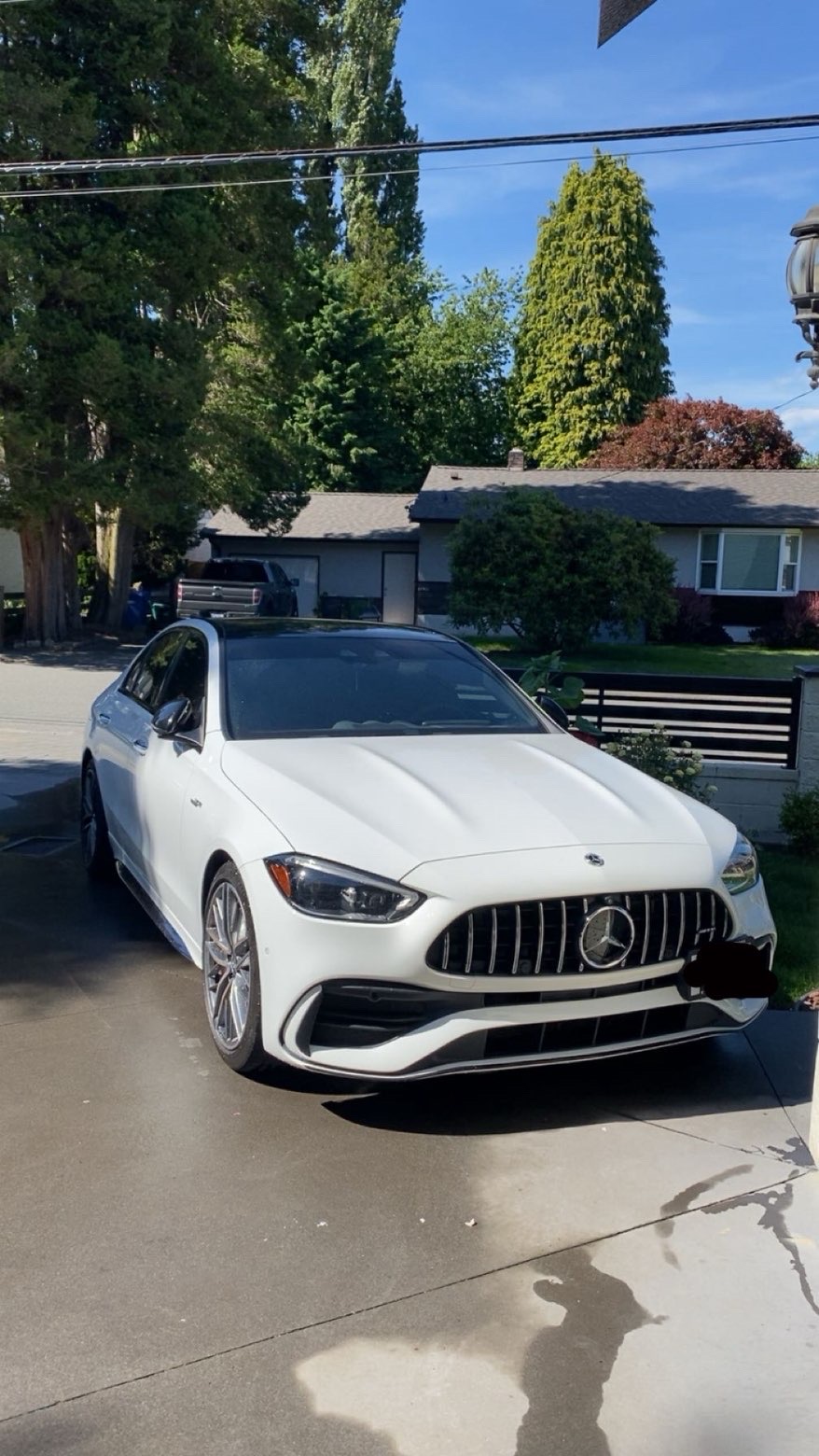 White Mercedes-AMG C43 detailed in a driveway